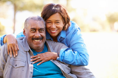 caregiver and elderly man smiling