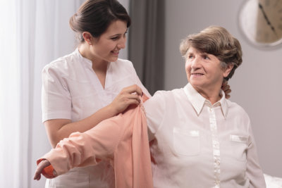caregiver dressing her patient